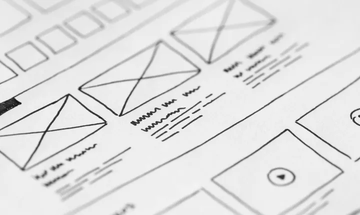 Hand-drawn website wireframes sketched on paper