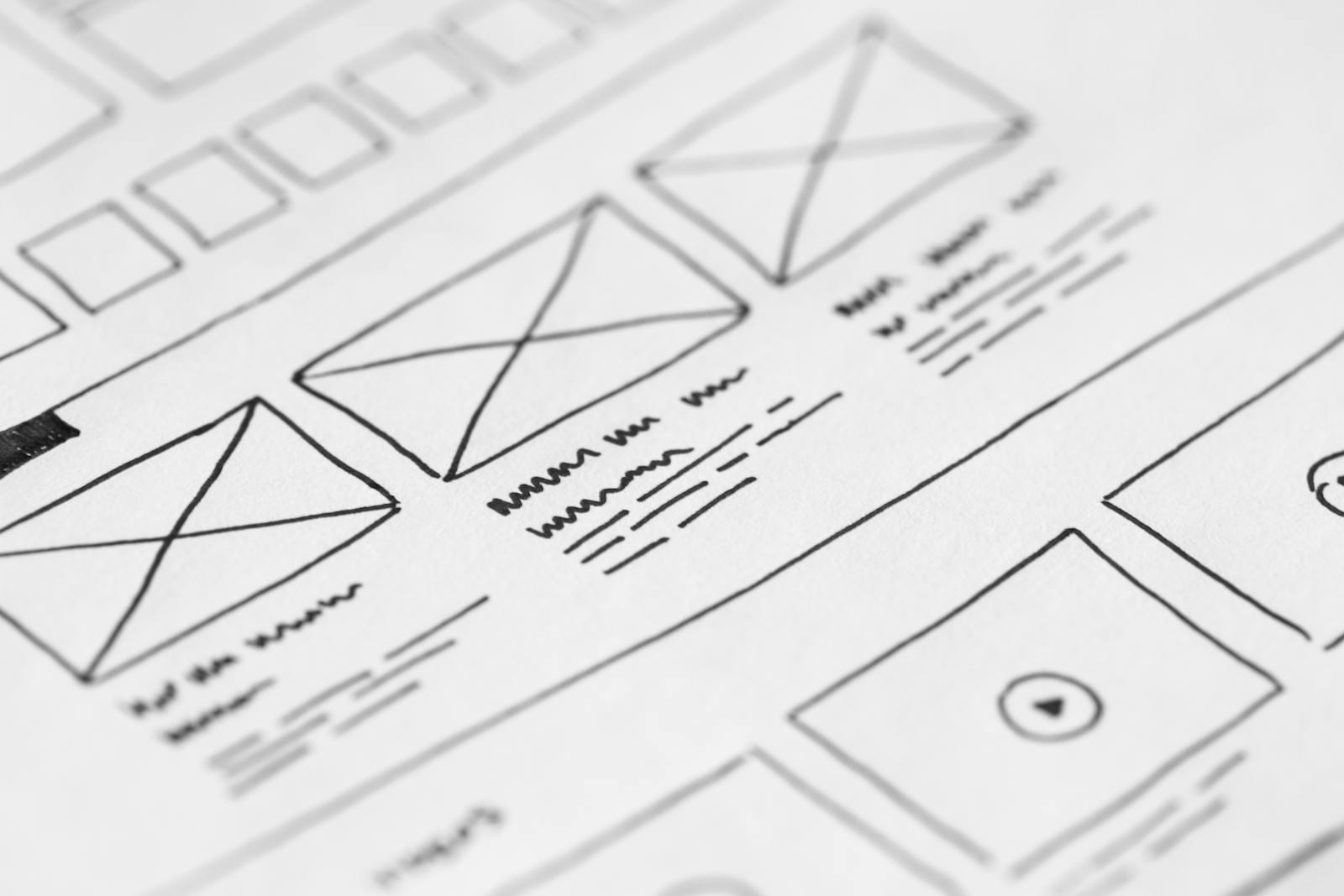 Hand-drawn website wireframes sketched on paper