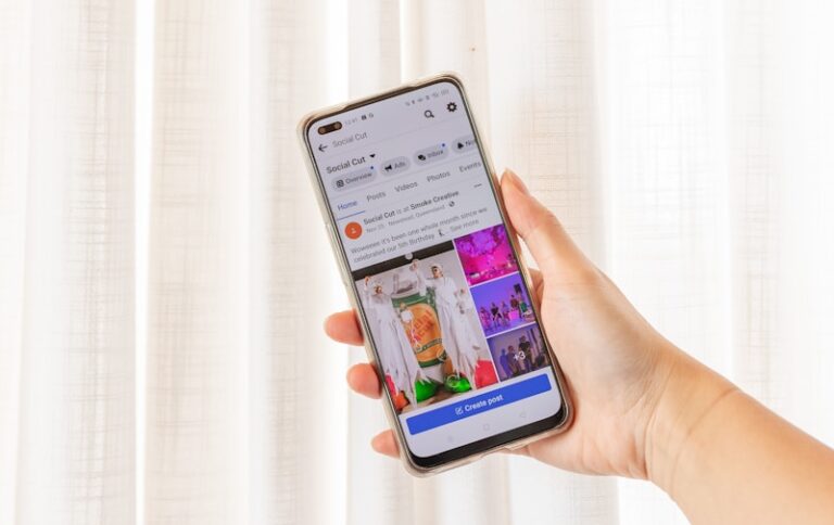 a person holding a cell phone in their hand